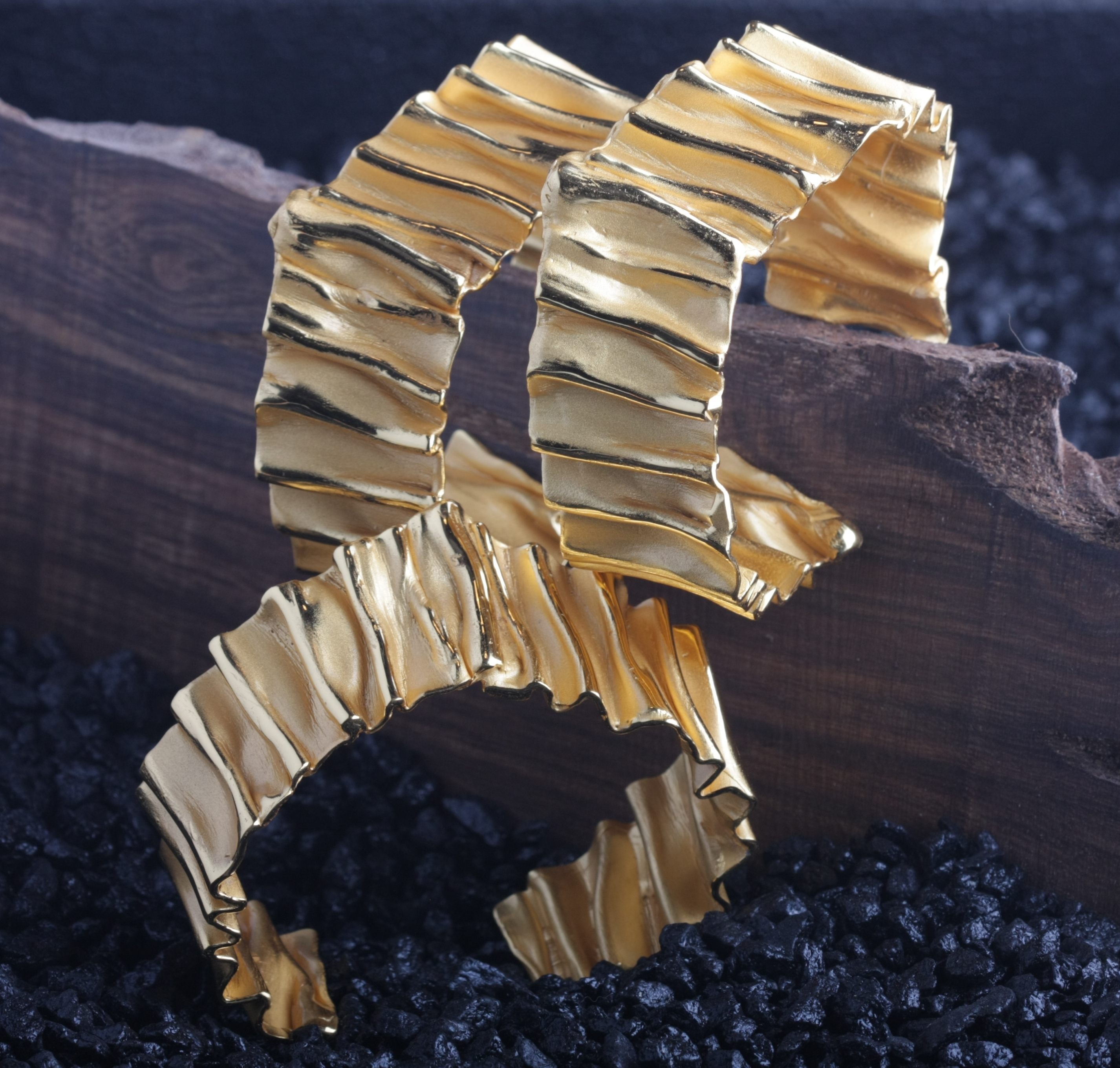 three gold crinkle bracelets